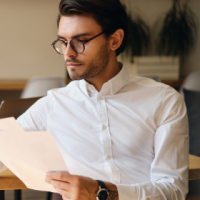 young-serious-businessman-in-eyeglasses-thoughtful-WU7QCKG-1.png